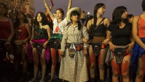 Protestors pain their legs red to symbolize the forced sterilizations. Credit: Eline van Nes/Al Jazeera