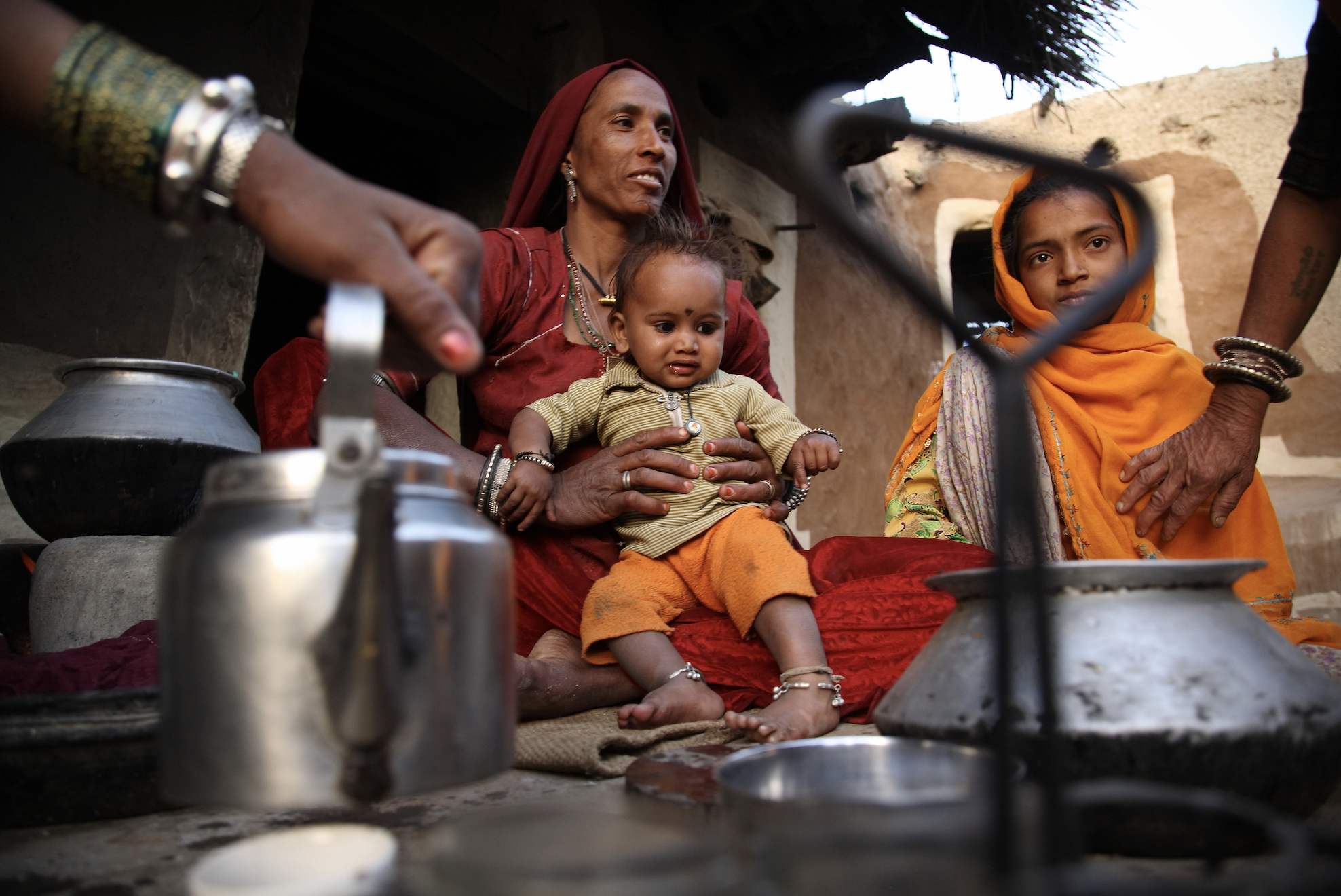 Tulsi Devi, the wife of a farmer, prepares tea at her home in Nagar Village, Rajasthan, India